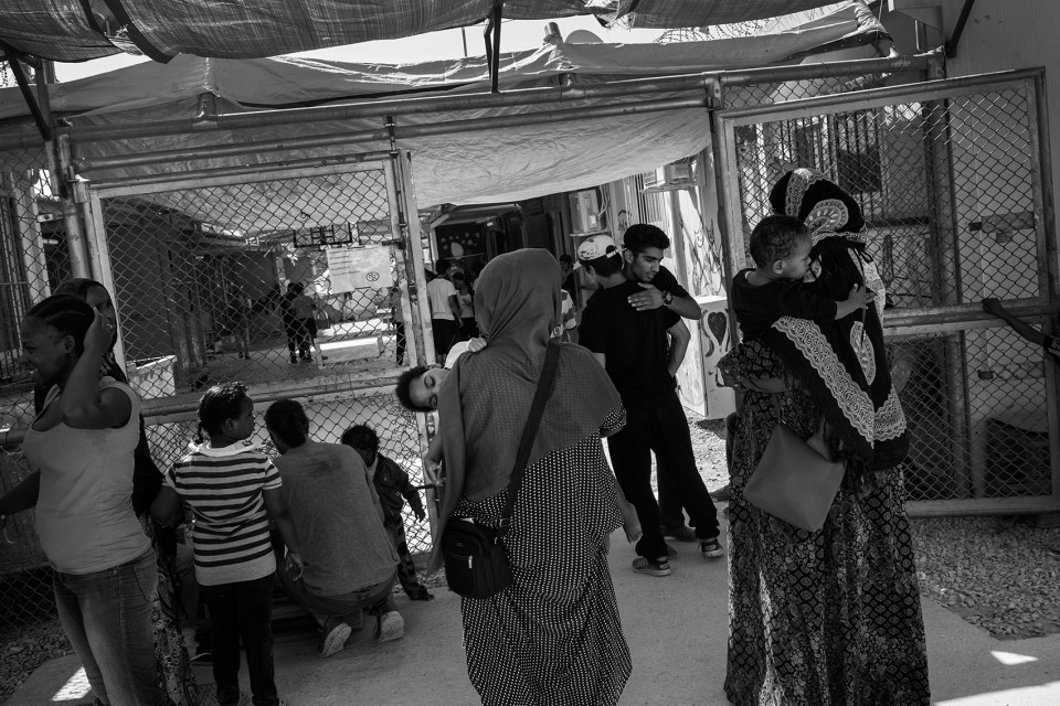 Mothers with children in front of the safe area for children at the refugee camp Moria, Lesbos, Greece Mothers with children in front of the safe area for children at the refugee camp Moria, Lesbos, Greece