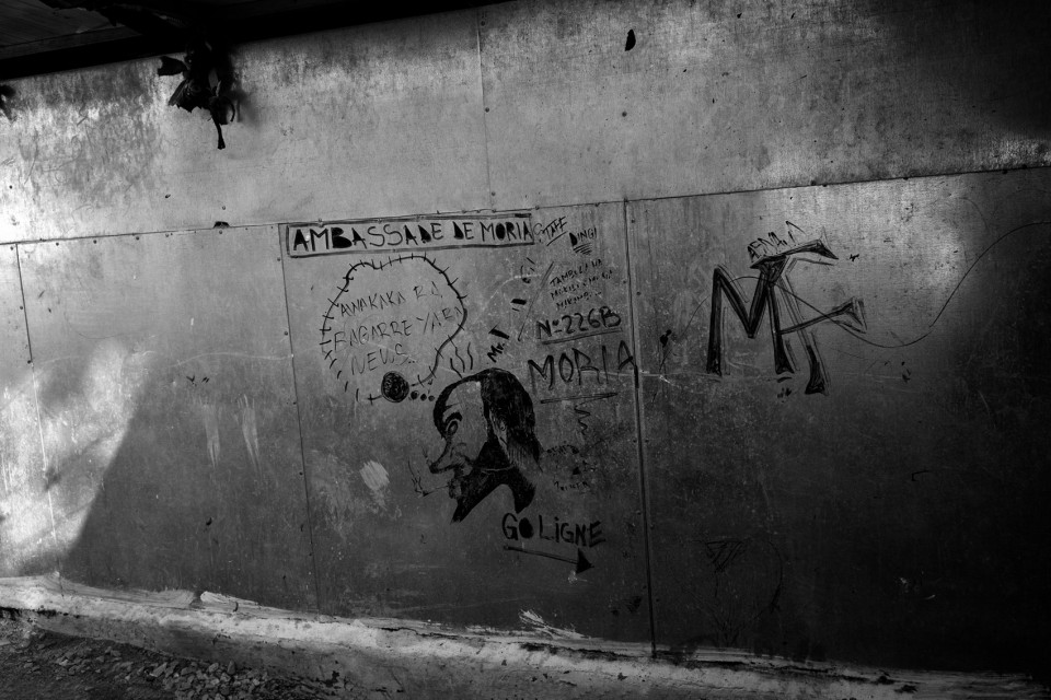 Graffiti at the back of showers inside the refugee camp Moria, Lesbos, Greece Graffiti at the back of showers inside the refugee camp Moria, Lesvos, Greece